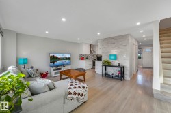 Living area featuring stairway, light wood-type flooring, and recessed lighting - 