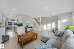 Living area featuring stairway, light wood finished floors, and recessed lighting - 