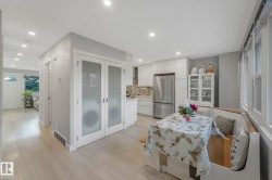 Dining room featuring light wood-style flooring and recessed lighting - 