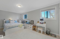 Bedroom featuring wood finished floors and ornamental molding - 