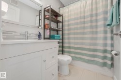 Bathroom featuring vanity, light tile patterned floors, and shower / tub combo with curtain - 