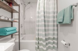 Bathroom with toilet and shower / bath combo with shower curtain - 