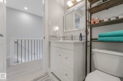 Bathroom with vanity and light wood-style flooring - 
