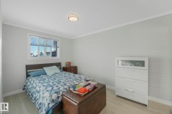 Bedroom with light wood-type flooring and ornamental molding - 