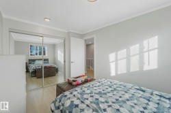 Bedroom with wood finished floors, ornamental molding, and a closet - 