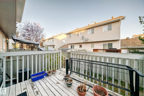 Wooden terrace with a residential view - #48 - 2503 24 Street Nw, Edmonton, AB - Outdoor With Deck Patio Veranda With Exterior