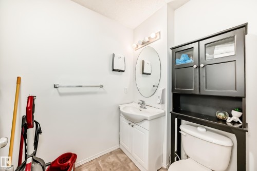 Half bath featuring vanity and toilet - #48 - 2503 24 Street Nw, Edmonton, AB - Indoor Photo Showing Bathroom