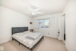 Bedroom featuring light carpet and a ceiling fan - 