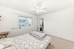 Bedroom with light carpet and a ceiling fan - 