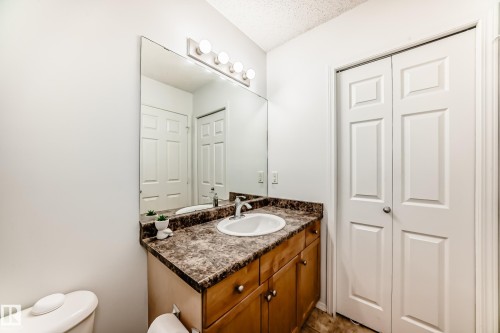 Bathroom with vanity and a textured ceiling - #48 - 2503 24 Street Nw, Edmonton, AB - Indoor Photo Showing Bathroom