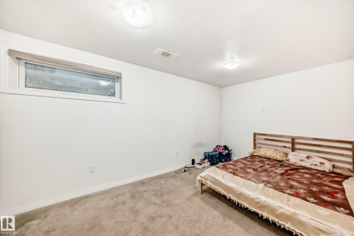 Carpeted bedroom featuring baseboards - #48 - 2503 24 Street Nw, Edmonton, AB - Indoor Photo Showing Bedroom
