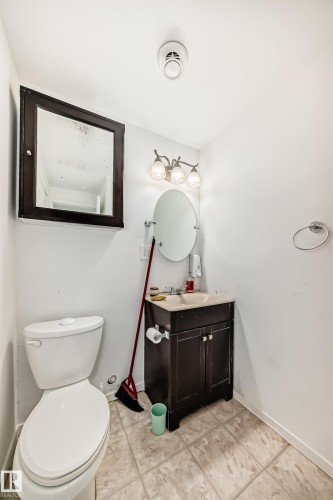 Bathroom featuring vanity and light tile patterned flooring - #48 - 2503 24 Street Nw, Edmonton, AB - Indoor Photo Showing Bathroom