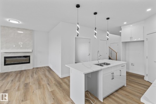 68 Waverly Way, Fort Saskatchewan, AB - Indoor Photo Showing Kitchen With Fireplace With Double Sink