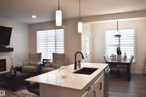38 Wiltree Terrace, Fort Saskatchewan, AB - Indoor Photo Showing Kitchen With Fireplace With Double Sink