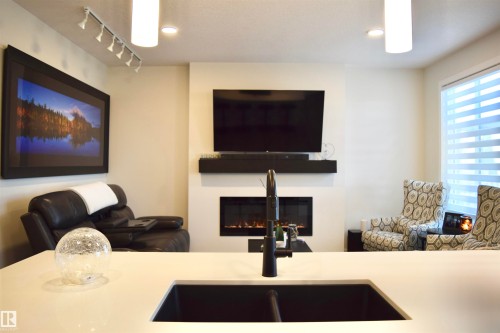 38 Wiltree Terrace, Fort Saskatchewan, AB - Indoor Photo Showing Kitchen With Fireplace With Double Sink
