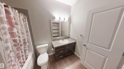 Full bath featuring dark wood-style flooring, vanity, and shower / bath combo - 