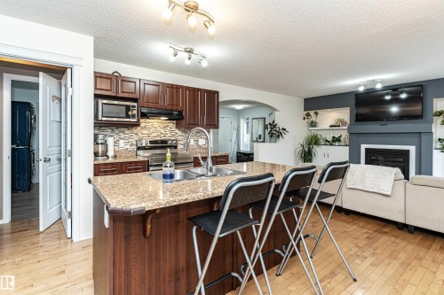 38 Rue Bouchard, Beaumont, AB - Indoor Photo Showing Kitchen With Fireplace With Double Sink