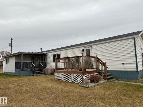 Back of property featuring a deck, a yard, and roof with shingles - 37 43 Avenue, Millet, AB - Outdoor With Deck Patio Veranda