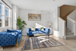 Living area with stairway and wood finished floors - 