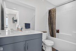 Full bath featuring vanity and shower / tub combo with curtain - 