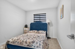 Bedroom with light colored carpet and baseboards - 