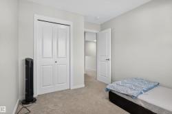 Bedroom featuring light colored carpet and a closet - 