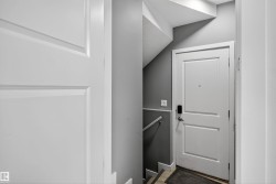 Entryway featuring wood finished floors and lofted ceiling - 