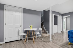 Dining area with light wood finished floors and stairway - 