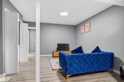 Bedroom featuring light wood-style floors and baseboards - 