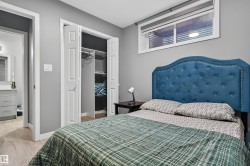 Bedroom featuring light wood-type flooring and a spacious closet - 