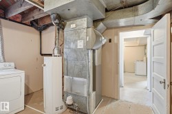 Utilities featuring washer / clothes dryer, water heater, and heating unit - 