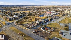 Aerial view of property and surrounding area featuring a nearby body of water - 