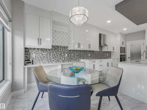 Dining space featuring a chandelier, light marble finish floors, and recessed lighting - 2412 14 Avenue, Edmonton, AB - Indoor Photo Showing Dining Room