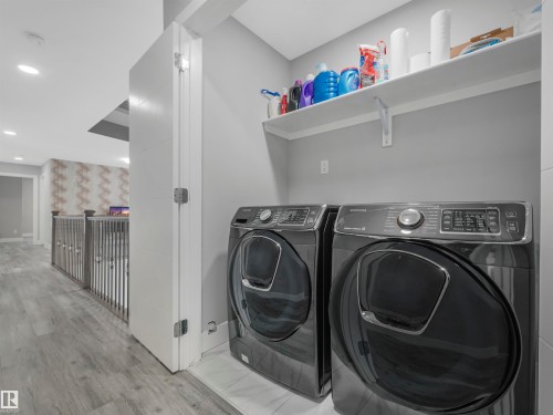 Washroom featuring wood finished floors, washing machine and dryer, and recessed lighting - 2412 14 Avenue, Edmonton, AB - Indoor Photo Showing Laundry Room