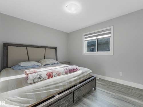 Bedroom featuring baseboards and wood finished floors - 2412 14 Avenue, Edmonton, AB - Indoor Photo Showing Bedroom