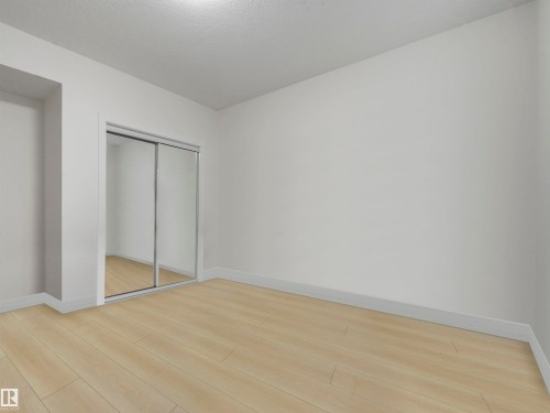 Unfurnished bedroom with light wood-style floors and a closet - 2412 14 Avenue, Edmonton, AB - Indoor Photo Showing Other Room