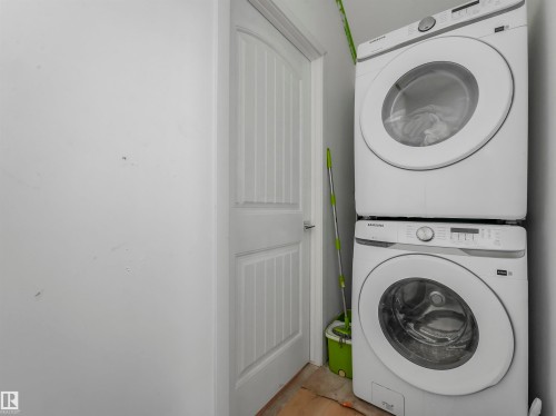 Laundry area with stacked washer and clothes dryer - 2412 14 Avenue, Edmonton, AB - Indoor Photo Showing Laundry Room