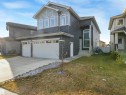 View of front of property with concrete driveway, a garage, a front lawn, and entry steps - 2412 14 Avenue, Edmonton, AB  - Outdoor With Facade 