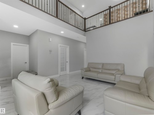 Living area with a high ceiling, marble finish floors, and recessed lighting - 2412 14 Avenue, Edmonton, AB - Indoor