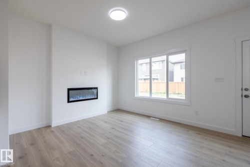 5025 Cawsey Link, Edmonton, AB - Indoor Photo Showing Other Room With Fireplace