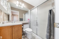 Bathroom featuring vanity, a shower stall, and light tile patterned flooring - 
