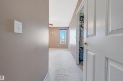 Hall with light carpet and a textured ceiling - 