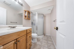 Bathroom with a stall shower, vanity, and a textured ceiling - 