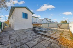 Rear view of property with a fenced backyard, a patio area, and a wooden deck - 