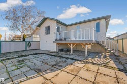 Rear view of property featuring a fenced backyard, a deck, a patio, and stairway - 