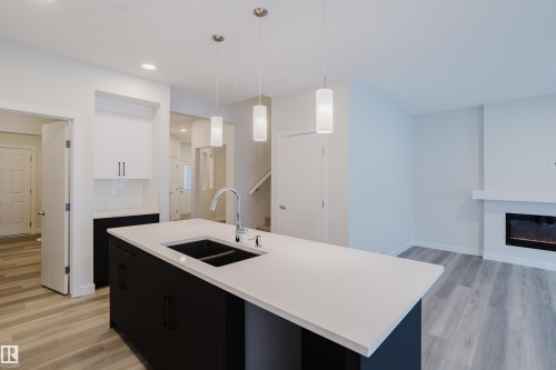 362 Bluff Cove, Leduc, AB - Indoor Photo Showing Kitchen With Fireplace With Double Sink