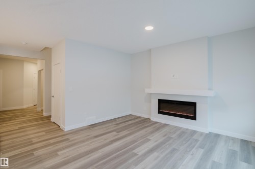 362 Bluff Cove, Leduc, AB - Indoor Photo Showing Living Room With Fireplace