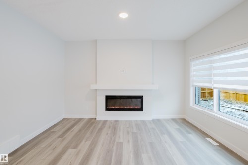 362 Bluff Cove, Leduc, AB - Indoor Photo Showing Living Room With Fireplace