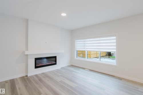 362 Bluff Cove, Leduc, AB - Indoor Photo Showing Living Room With Fireplace