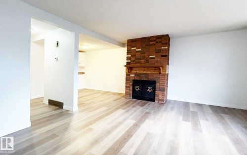10427 24 Avenue, Edmonton, AB - Indoor Photo Showing Living Room With Fireplace